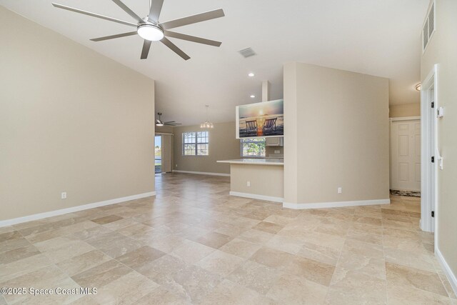 unfurnished living room featuring lofted ceiling and ceiling fan with notable chandelier