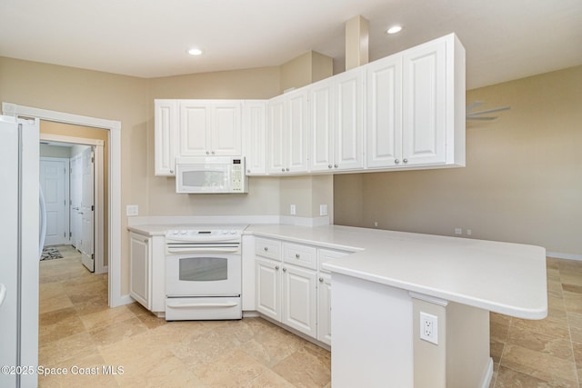 kitchen featuring white appliances, white cabinetry, and kitchen peninsula