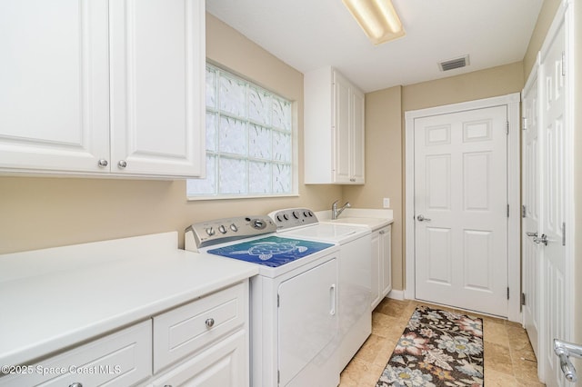 laundry area with washer and dryer, cabinets, and sink