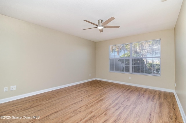 spare room featuring light wood-type flooring and ceiling fan