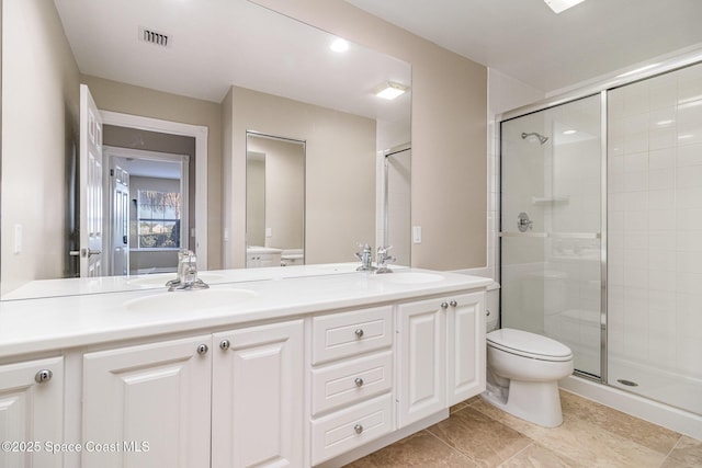 bathroom with toilet, tile patterned flooring, a shower with door, and vanity