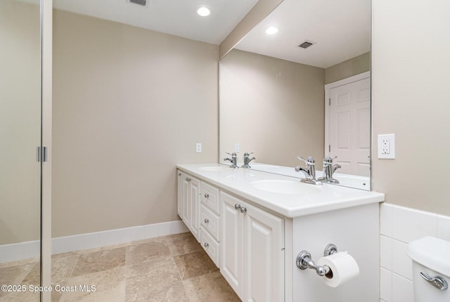 bathroom with toilet and vanity