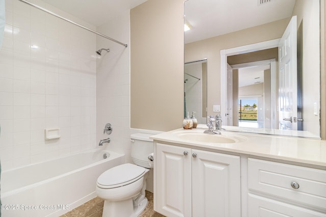 full bathroom featuring toilet, vanity, tile patterned flooring, and tiled shower / bath combo