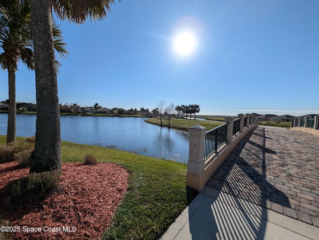 dock area featuring a lawn and a water view