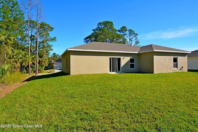 back of house with a lawn