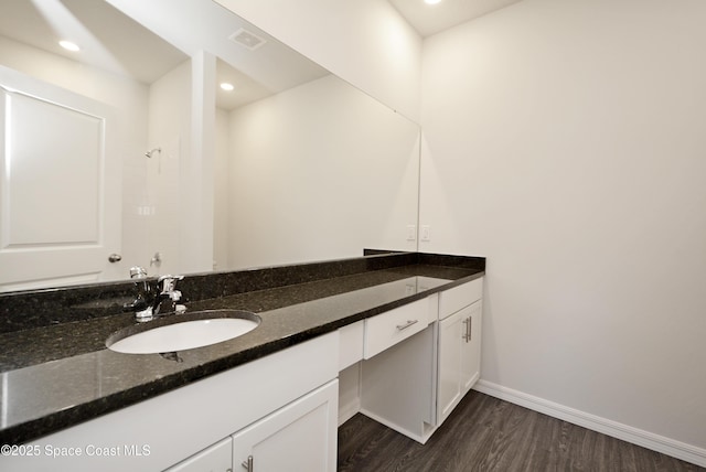 bathroom with hardwood / wood-style floors and vanity