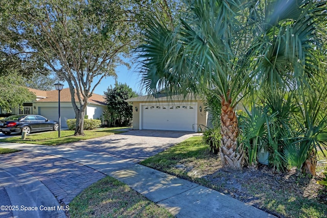 view of front of home with a front yard and a garage