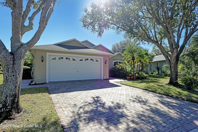 ranch-style house with a garage and a front lawn