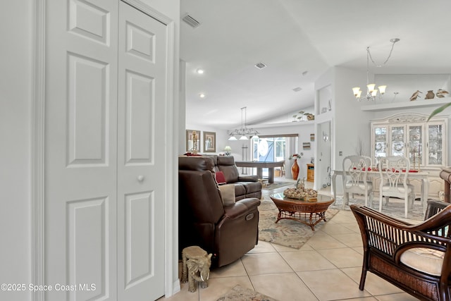 tiled living room featuring a chandelier and lofted ceiling