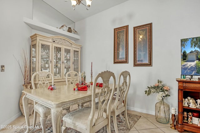 tiled dining space featuring a notable chandelier