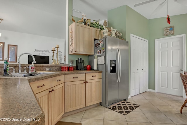 kitchen featuring ceiling fan, light tile patterned flooring, stainless steel refrigerator with ice dispenser, and light brown cabinetry