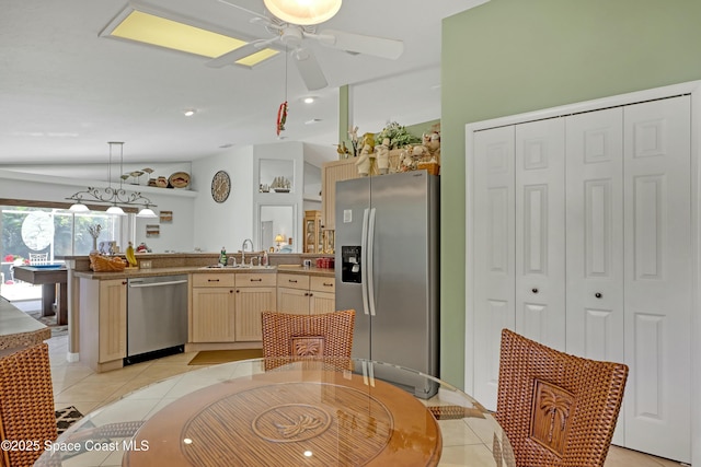 kitchen featuring lofted ceiling, hanging light fixtures, billiards, light tile patterned floors, and appliances with stainless steel finishes