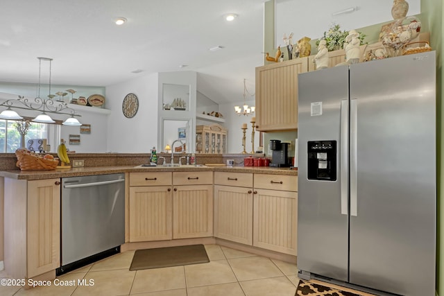 kitchen featuring a notable chandelier, decorative light fixtures, sink, and appliances with stainless steel finishes