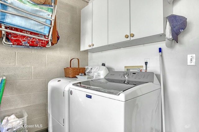 laundry area featuring cabinets and washer and dryer