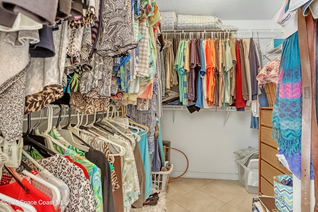 spacious closet with tile patterned floors