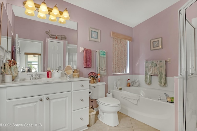 bathroom with tile patterned flooring, vanity, toilet, and a washtub