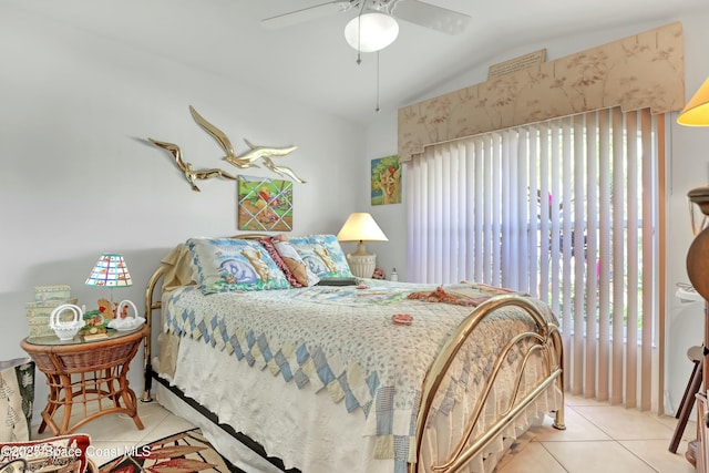 tiled bedroom with ceiling fan and lofted ceiling