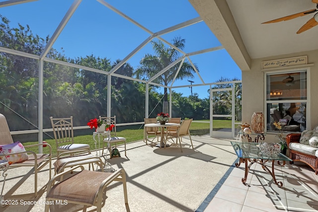 view of patio with glass enclosure and ceiling fan