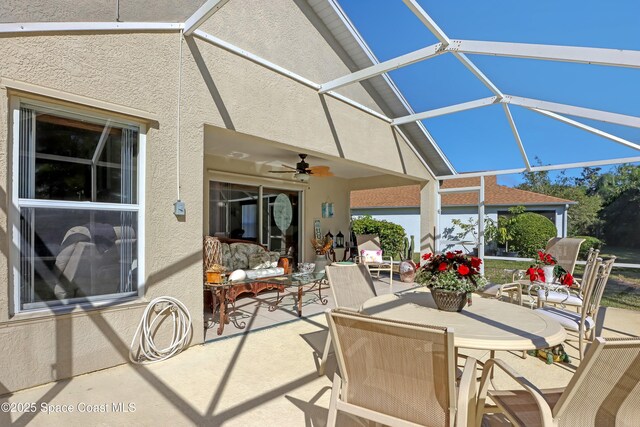 view of patio / terrace featuring ceiling fan and a lanai