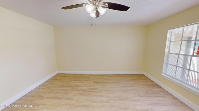 empty room with ceiling fan, a textured ceiling, and light hardwood / wood-style flooring