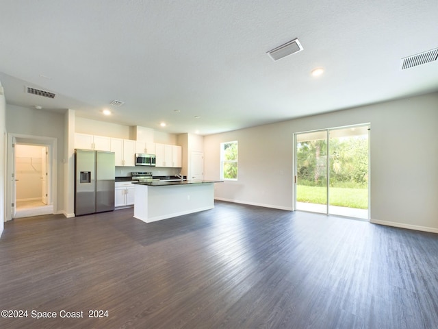 kitchen featuring appliances with stainless steel finishes, dark hardwood / wood-style flooring, sink, white cabinets, and a kitchen island