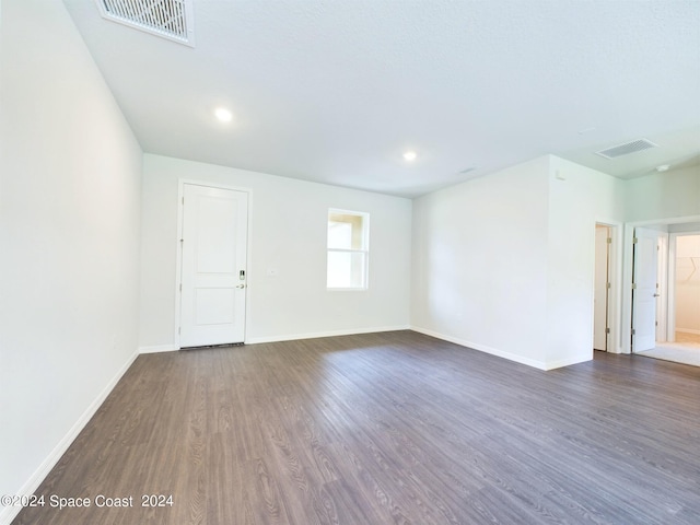 unfurnished room with dark hardwood / wood-style flooring