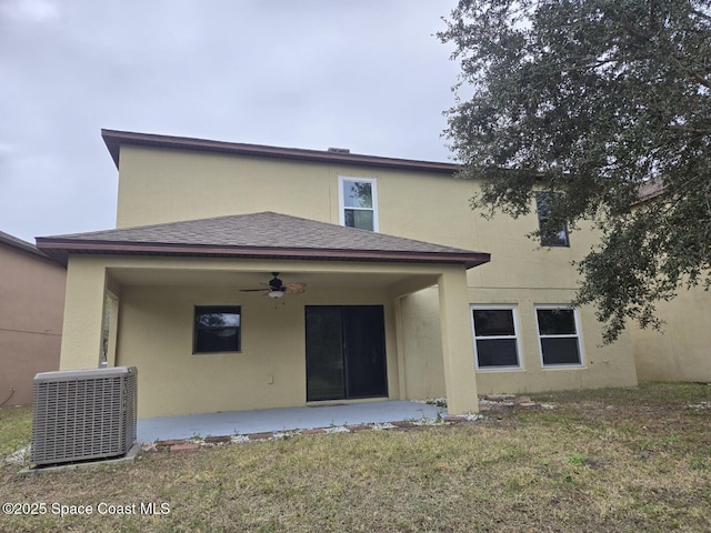 rear view of property featuring a lawn, ceiling fan, a patio, and central AC unit