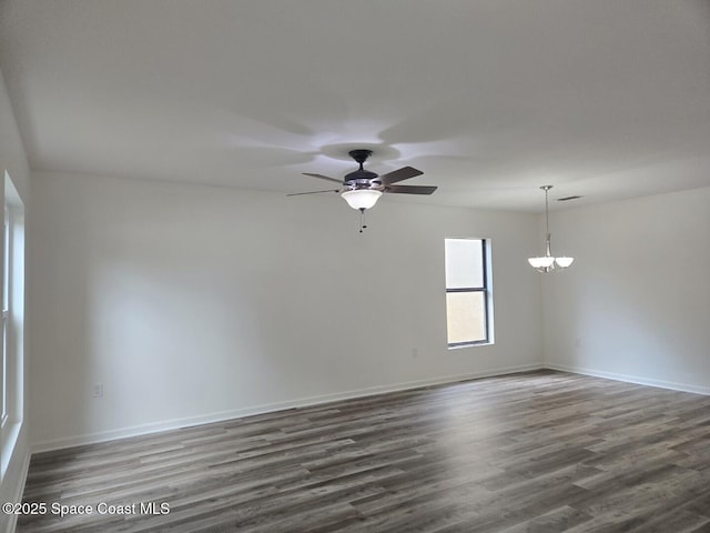 empty room featuring ceiling fan and dark wood-type flooring