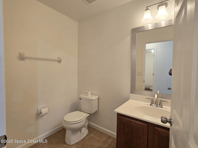 bathroom featuring tile patterned flooring, vanity, and toilet