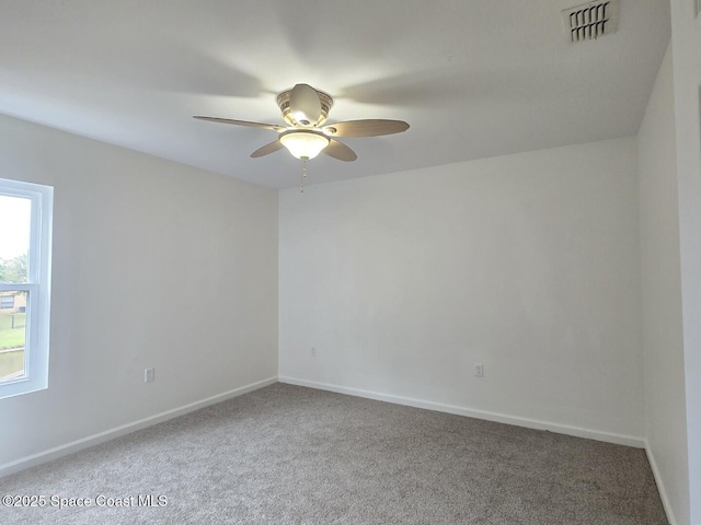 carpeted spare room with ceiling fan