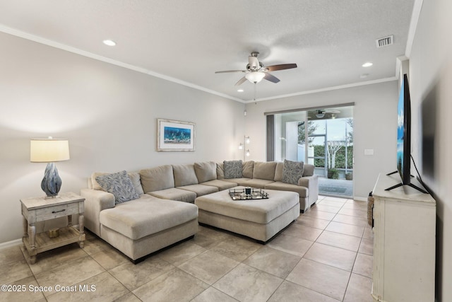 living room with a textured ceiling, ceiling fan, and ornamental molding