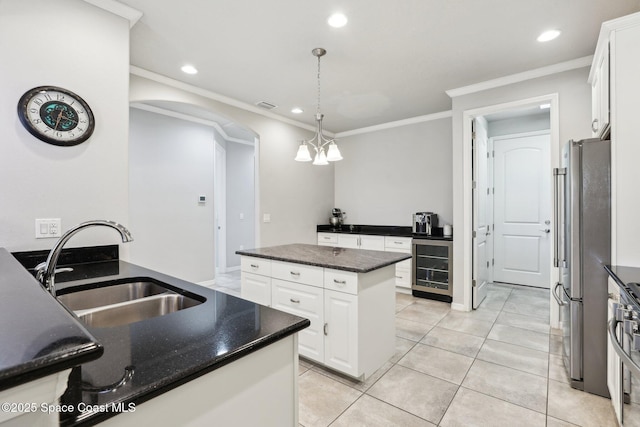 kitchen with white cabinetry, stainless steel fridge, beverage cooler, a kitchen island, and pendant lighting