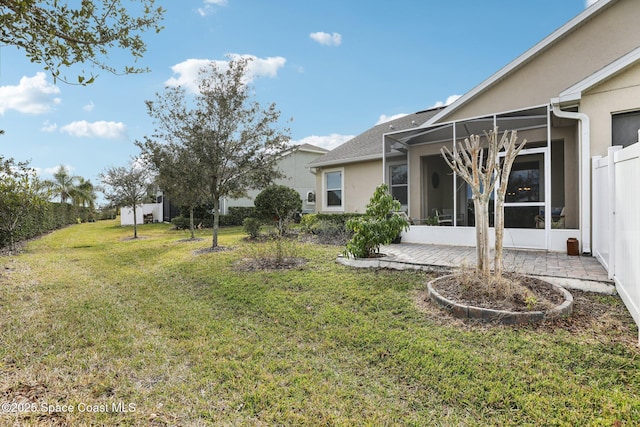 view of yard featuring a lanai and a patio area