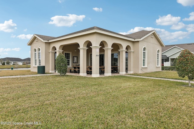 mediterranean / spanish house featuring cooling unit and a front yard