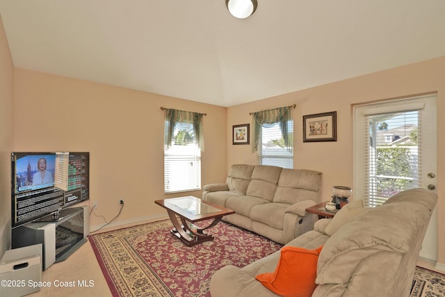 living room featuring vaulted ceiling and a wealth of natural light