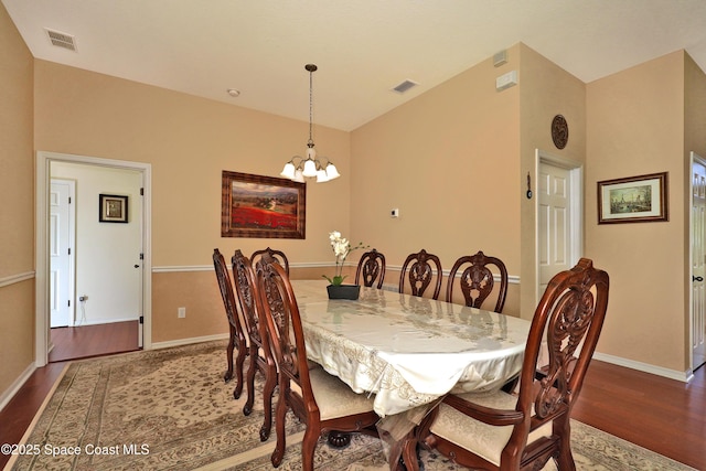 dining room with an inviting chandelier and dark hardwood / wood-style floors