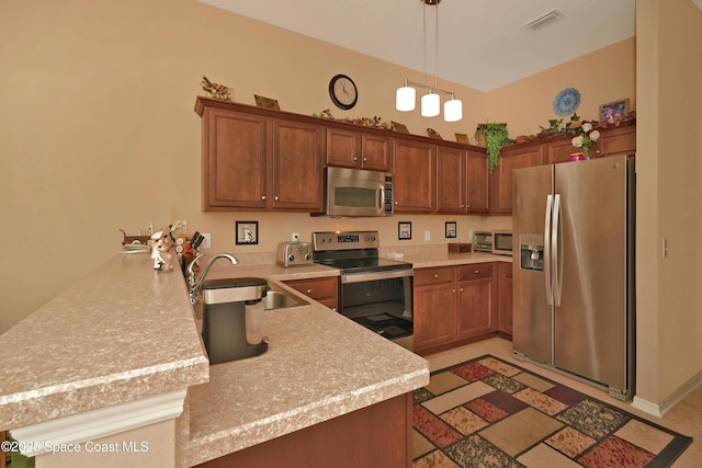 kitchen with decorative light fixtures, kitchen peninsula, appliances with stainless steel finishes, and sink