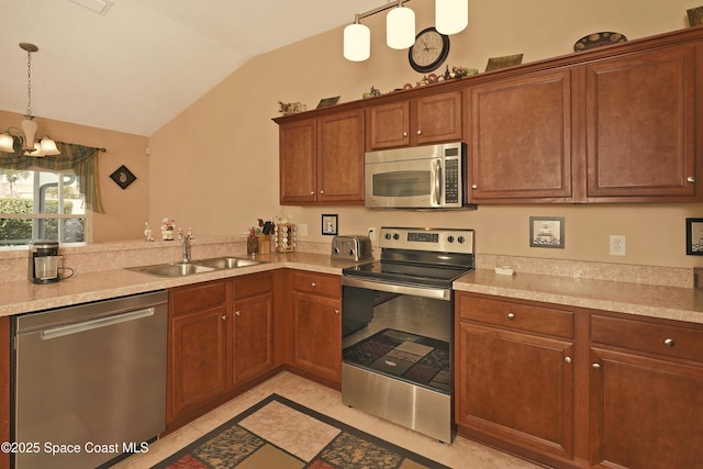 kitchen featuring stainless steel appliances, vaulted ceiling, pendant lighting, and sink