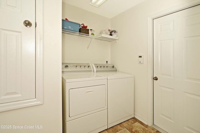 laundry room featuring independent washer and dryer and light tile patterned floors