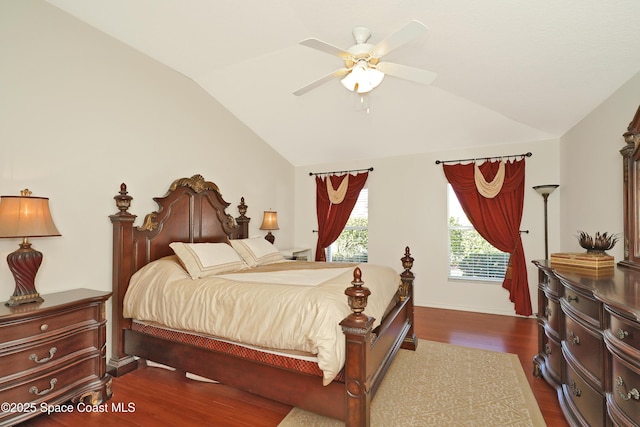 bedroom with lofted ceiling, ceiling fan, and dark wood-type flooring