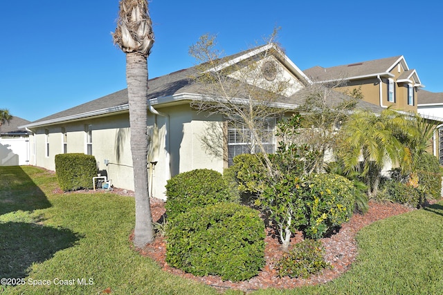 view of property exterior featuring a lawn