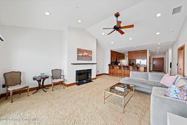 living room featuring vaulted ceiling, ceiling fan, and light carpet