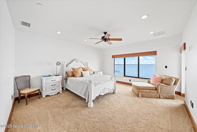 bedroom with a water view, ceiling fan, and carpet floors