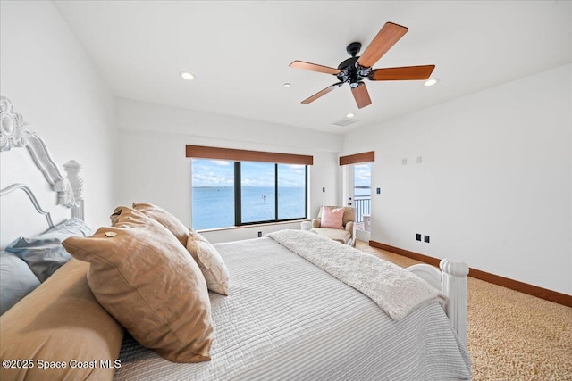 bedroom featuring carpet, a water view, and ceiling fan