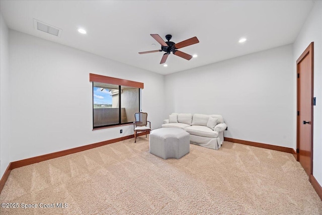 sitting room featuring ceiling fan and carpet