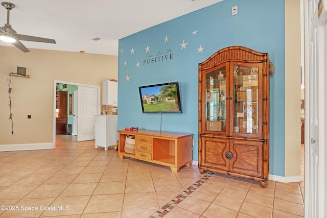 interior space with ceiling fan