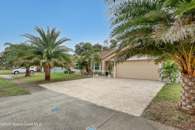 view of front of home featuring a front yard and a garage