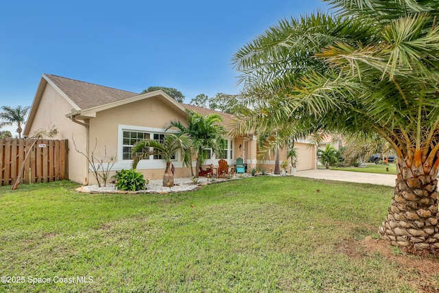 view of front of home with a front yard and a garage