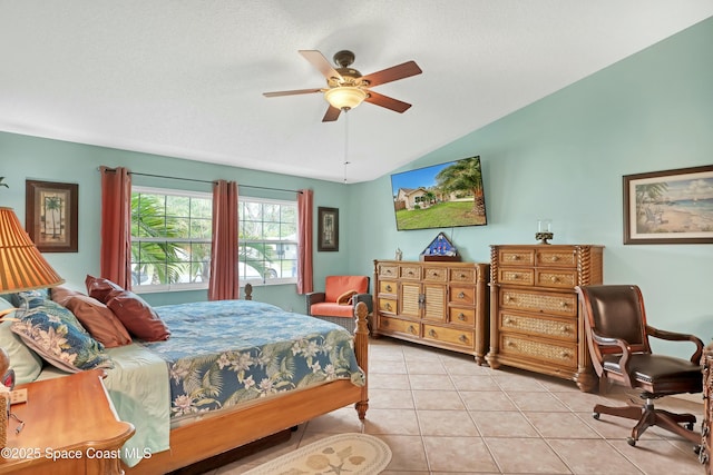 bedroom with light tile patterned flooring, a textured ceiling, ceiling fan, and vaulted ceiling