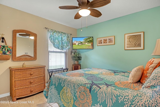 bedroom with ceiling fan and light tile patterned floors